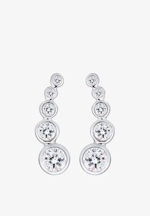 Sølvøreringe med et gradueret design med cirkulære klare krystaller, der varierer i størrelse, arrangeret i et buet mønster.