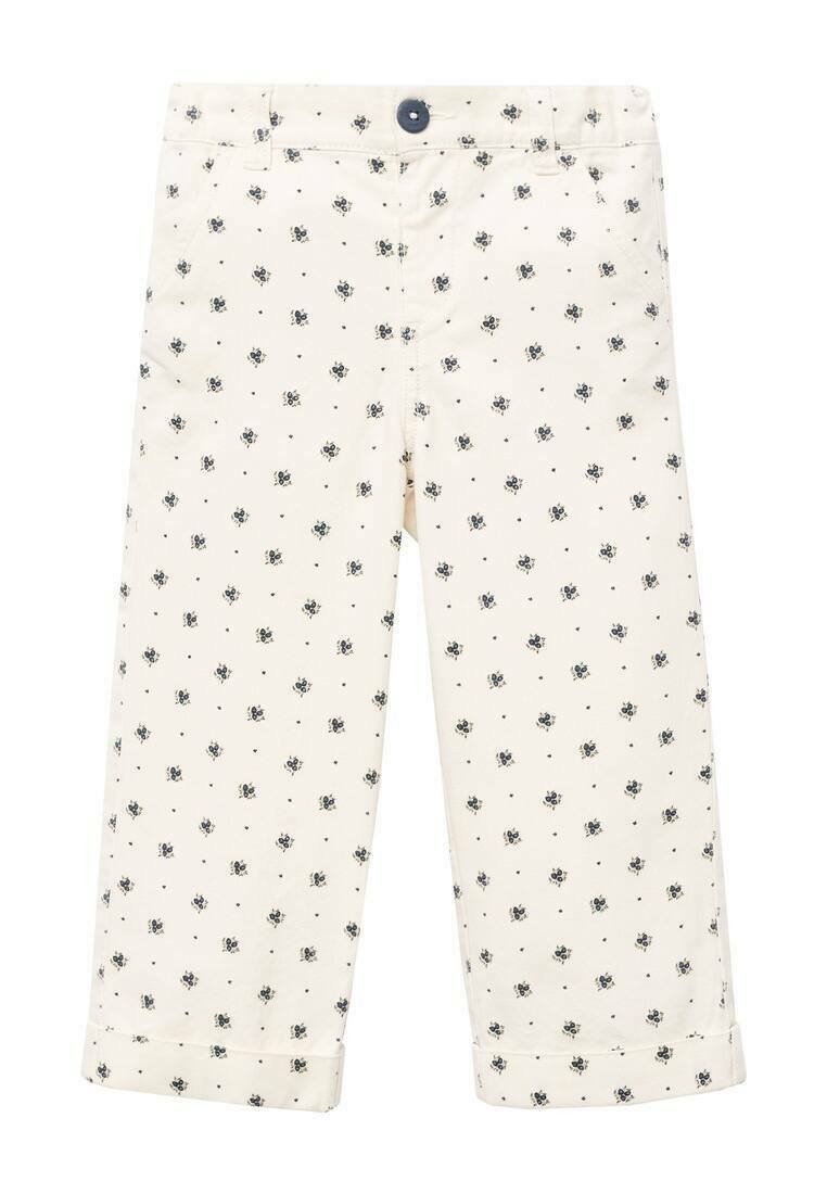 Pantaloni per bambini color crema con piccoli motivi floreali blu navy e orli risvoltati, dotati di una chiusura con bottone scuro in vita.