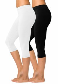 Leggings capri noir et blanc en matériau extensible et lisse. Dotés d'une large taille élastique et de jambes ajustées, se terminant juste en dessous du genou.