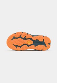 Rubber outsole with textured orange pattern and deep grooves, designed for traction. Dark blue material covers the upper section.