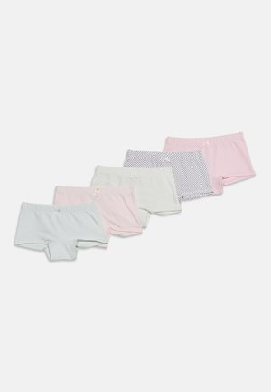 Cinq paires de boxers en coton pour filles, disposées en rangée, avec des couleurs pastel unies et des motifs à pois avec de petits nœuds sur les ceintures.