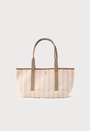 Beige-hellbraun gestreifte Tragetasche mit zwei langen, robusten Griffen und einem kleinen goldenen Knopfverschluss in der Mitte oben.