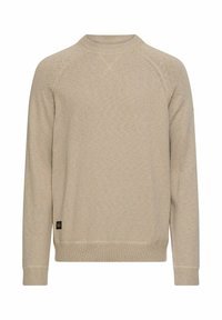Beige knitted sweater with a crew neck, long raglan sleeves, ribbed cuffs, and hem. Features a small logo label at the lower left side.