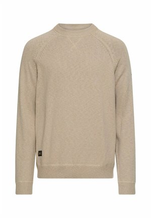 Beige gebreide trui met een ronde hals, lange raglanmouwen, geribde manchetten en zoom. Heeft een klein logolabel aan de linkeronderkant.