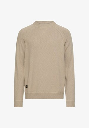 Beżowy sweter z dzianiny z okrągłym dekoltem, długimi rękawami raglanowymi, ściągaczami na mankietach i dolnym brzegu. Na dole po lewej stronie znajduje się mała metka z logo.