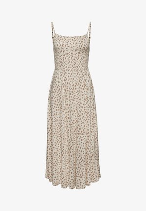 Heled beež kleit pruunide täppidega, peened õlapaelad, smock-kere ja voolav seelik, mis ulatub põlvest allapoole.