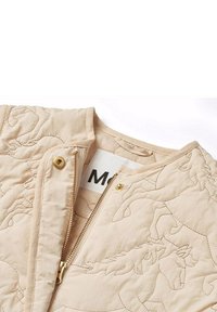 Ljusbeige quiltad jacka med hästbroderi, med gyllene dragkedja och tryckknappsstängning samt rund krage. Inre etikett synlig.