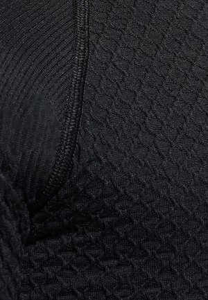 Tissu noir texturé présentant un motif de diamant subtil, avec des coutures renforcées. Le matériau est extensible et moulant.