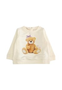 Felpa color crema con grafiche di un teddy bear peluche, con pelliccia marrone e un fiocco viola, scollatura rotonda e maniche lunghe.