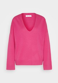 Jersey de cuello en V rosa elaborado en material de punto suave. Presenta mangas largas y un corte relajado, con puños y dobladillo acanalados.