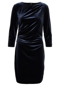 Svart sammet klänning med långa ärmar, draperad frontdetalj, rund halsringning och en figursydd silhuett, med en diskret dragkedja bak.