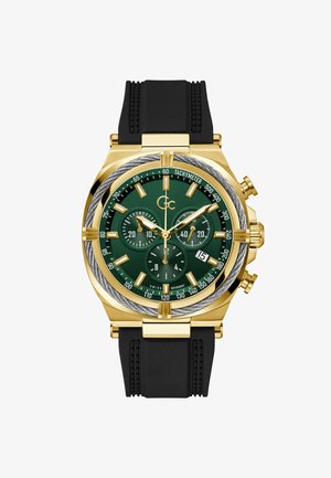 Zegarek chronograf w złotym odcieniu z zieloną tarczą, czarnym paskiem gumowym, podtarczami do sekund i minut oraz skalą tachymetru na lunecie.
