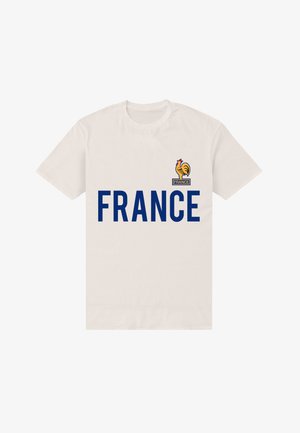 Bílý bavlněný tričko s výrazným modrým nápisem "FRANCIE" a nad ním emblém kohouta, který reprezentuje národní identitu.