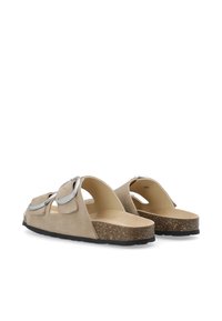 Beige suède slip-on sandaal met een kurken voetbed, een brede band met zilveren accenten en een getextureerde zwarte rubberen zool.