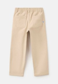 Bež hlače iz bombažne mešanice z elastičnim pasom, dvema zadnjima žepoma in šivanjem, z enotno barvo in ravnim krojem.
