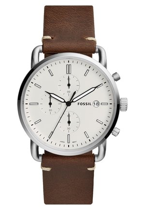 Round silver Fossil wristwatch with white dial, three subdials, date display, black hour markers, and brown leather strap.