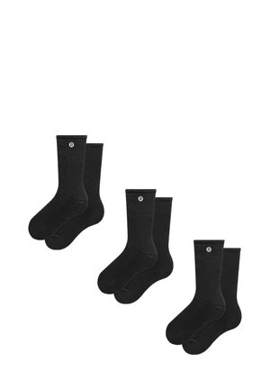 Chaussettes en coton noires, texture côtelée, longueur mi-mollet, avec un petit logo. Quatre paires disposées en deux ensembles. Douces, de couleur unie.