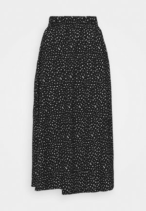 Zwarte midirok met wit onregelmatig stippenpatroon en elastische tailleband, hangend plat tegen een witte achtergrond getoond.