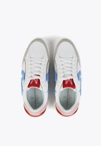 White sneakers with blue felt accents, red and pink details, and perforated toe. Smooth leather and fabric materials, round toe shape.