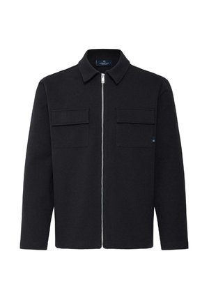 Veste noire à manches longues avec col, fermeture éclair à l'avant et deux poches à rabat sur la poitrine, posée à plat sur un fond blanc.