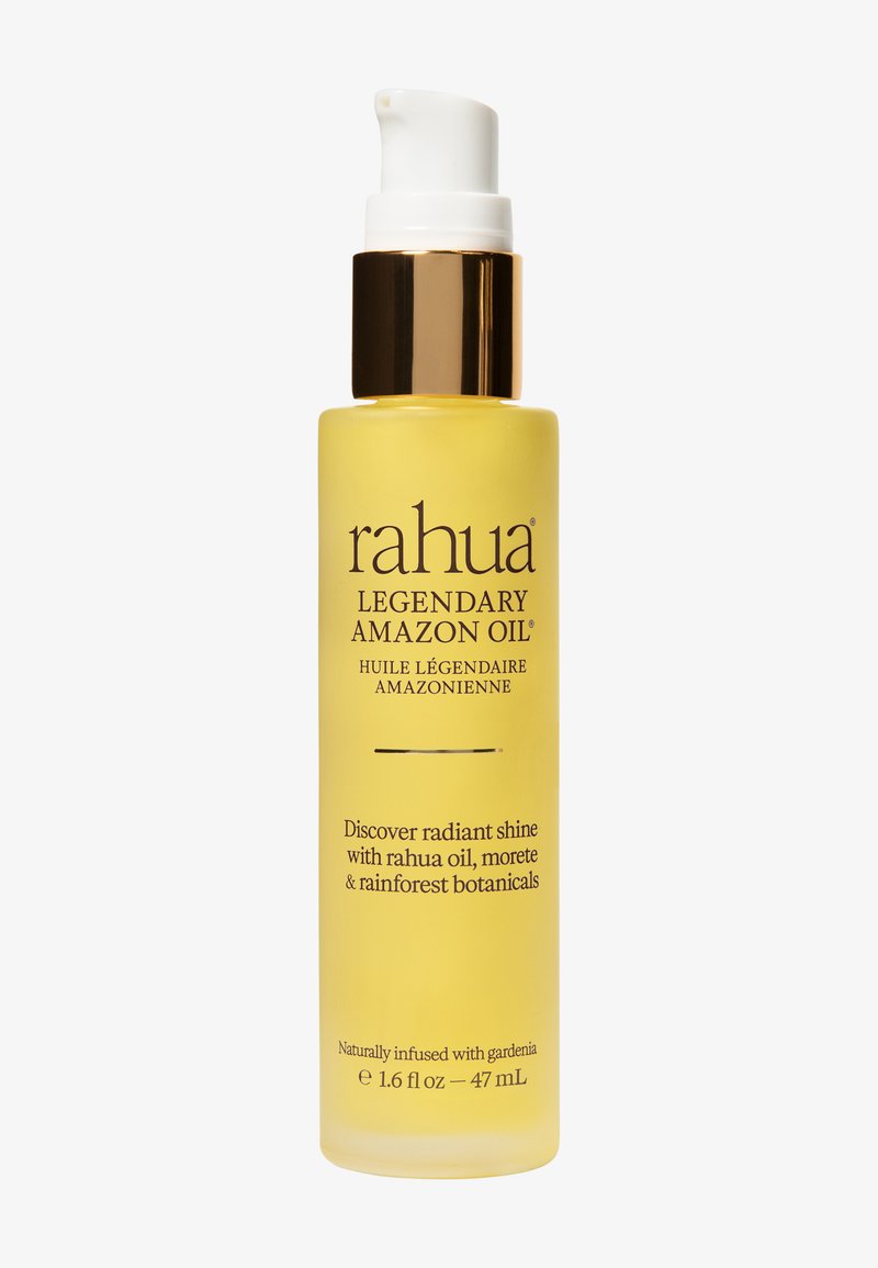 Rahua Legendary Amazon Oil in una bottiglia gialla da 47 mL con pompa bianca, collarino dorato, infusa con gardenia, morere e botaniche della foresta pluviale.