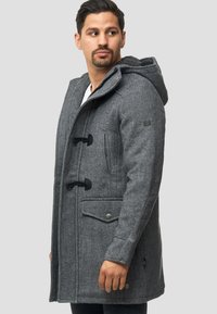 Abrigo duffle de mezcla de lana gris con capucha, botones de toggle, bolsillos laterales y tejido texturizado. Presenta un parche con logo en la manga.
