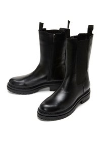 Black leather ankle boots featuring a smooth finish, elastic side panels, zipper closure, and rugged rubber soles.