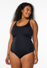 Zwarte éénstuk zwempak met een ronde hals, verstelbare banden en zijdelingse plooien. Gemaakt van een gladde rekbare stof voor comfort.