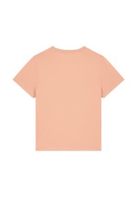 T-shirt à manches courtes de couleur pêche, en coton, avec un col rond et une texture lisse. Pas de motifs visibles ni d'accents.