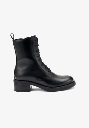 Bottine noire en cuir avec une pointe ronde, un laçage à l'avant et un petit talon carré. Comprend une languette à l'arrière pour un enfilage facile.