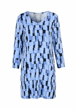 Langærmet tunika med V-udskæring, der har et geometrisk mønster af blå og sorte rektangulære former.