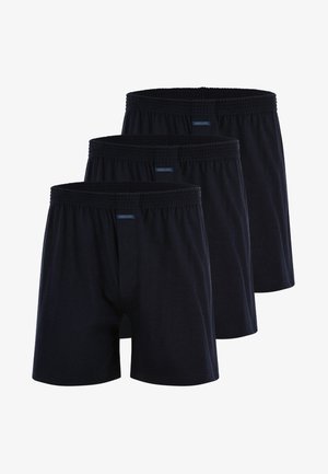 Trzy pary bawełnianych bokserek w ciemnogranatowym kolorze z elastycznym pasem i otworem z przodu, o prostej, gładkiej fakturze.