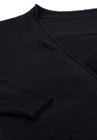 Černý pletený cardigan s designem ve tvaru V, žebrovanými manžetami a hladkým povrchem. Žádné viditelné vzory ani kování.