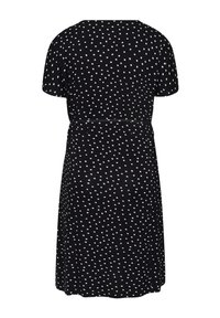 Robe noire longueur genou avec manches courtes, à pois blancs, et ceinture cintrée à la taille, vue de dos.