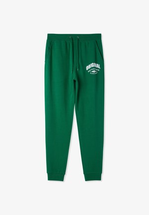 Zielone bawełniane spodnie dresowe z regulowanym sznurkiem, bocznymi kieszeniami oraz białym nadrukiem "ORIGINAL" na przodzie. Regularny krój.