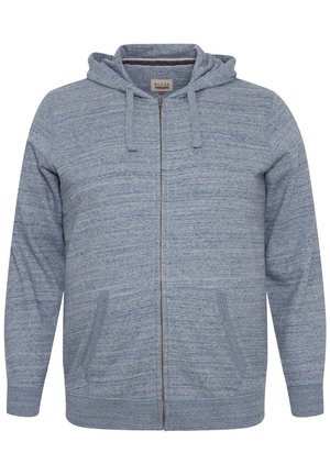 Sudadera azul con cremallera hecha de una tela texturizada con un patrón jaspeado. Cuenta con capucha, bolsillos frontales y puños acanalados.