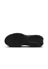 Black athletic shoe sole with textured grip patterns, featuring grooves for traction and a lightweight construction.