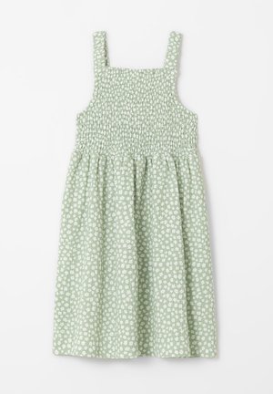 Robe sans manches vert clair avec corsage smocké et petit motif floral blanc, étalée à plat sur fond blanc.