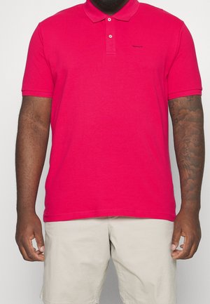 Polo shirt in felroze katoen met een kraag, twee knopen en een klein zwart logo op de borst. Korte mouwen en rechte zoom.