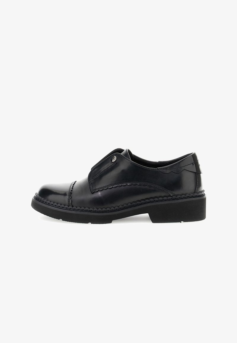 Black leather slip-on shoes with a rounded toe, decorative stitching, and a rubber sole. Features a subtle side accent and smooth texture.