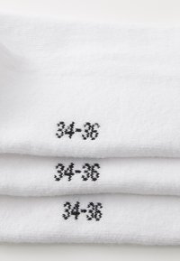 White cotton socks with three visible black printed size markings "34-36." Soft texture and ribbed design.