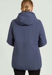 Marineblaue Kapuzenjacke aus strukturiertem Stoff mit elastischen Bündchen, lockerem Schnitt und verstellbarem Kordelzug an der Kapuze.