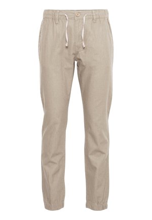 Beige afslappede bukser med elastisk taljebånd, knaplukning, snor, sidelommer og elastiske kanter ved anklerne.