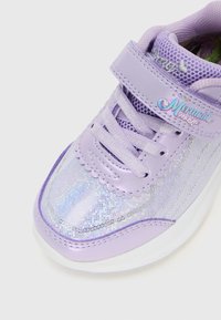 Child’s lavender sneaker with iridescent sequins, velcro strap labeled "Mermaid Magic," and matching satin laces on a white sole.