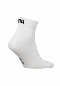 Weiße Knöchelsocken mit geripptem Bündchen, versehen mit schwarzem Logo an der Seite und Größenangabe an der Unterseite. Glatte Textur und enganliegende Form.