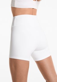 White athletic shorts with a high waistband, smooth texture, and fitted design. No visible patterns or hardware details present.