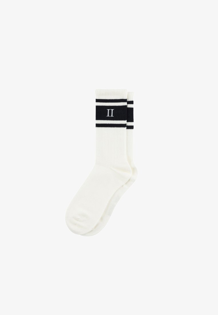 White athletic socks with a ribbed texture, featuring black stripes and a centered "II" in black. Designed for comfort and style.