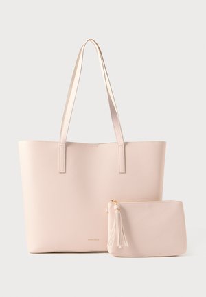 Large light pink tote bag with two straps and a matching small pouch with tassel zipper pull, both placed on a white background.
