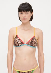 Driekhoekbikini in luipaardprint, met een veelkleurige rand (rood, blauw, geel) en dunne bandjes. Gemaakt van zachte, elastische stof.