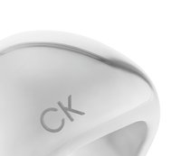 Silver metal ring with a smooth, rounded design featuring a small engraved "CK" logo. Reflective surface and polished finish.